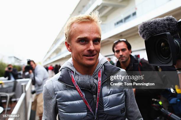 Heikki Kovalainen of Finland and Lotus arrives in the paddock during previews to the United States Formula One Grand Prix at Circuit of The Americas...