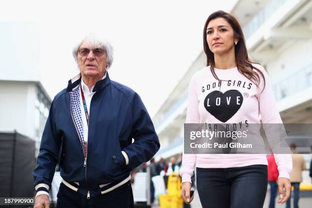 Supremo Bernie Ecclestone and his wife Fabiana Flosi arrive in the paddock during previews to the United States Formula One Grand Prix at Circuit of...