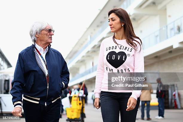 Supremo Bernie Ecclestone and his wife Fabiana Flosi arrive in the paddock during previews to the United States Formula One Grand Prix at Circuit of...