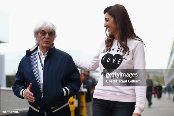 Supremo Bernie Ecclestone and his wife Fabiana Flosi arrive in the paddock during previews to the United States Formula One Grand Prix at Circuit of...