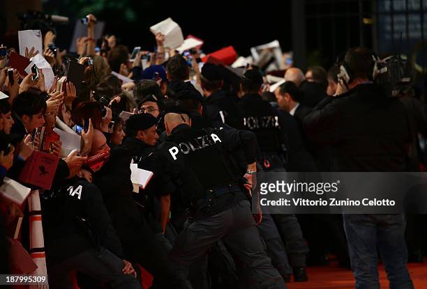 Security holds back the crowd at the 'The Hunger Games: Catching Fire' Premiere during The 8th Rome Film Festival at Auditorium Parco Della Musica on...