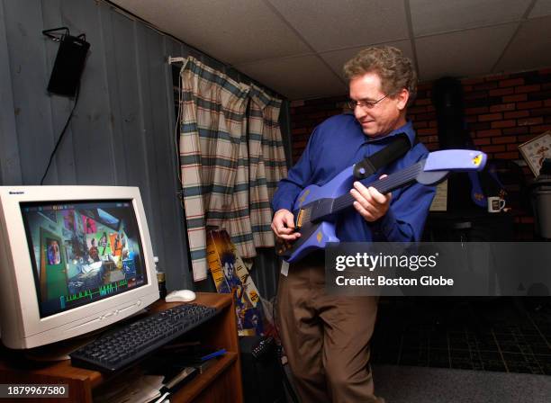 Framingham, MA Programmer Mike Fritz playing "Virtual Guitar" in his Framingham basement. Fritz was the script writer for a company of about 22...