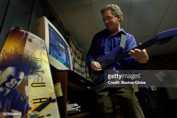 Framingham, MA Programmer Mike Fritz playing "Virtual Guitar" in his Framingham basement. Fritz was the script writer for a company of about 22...