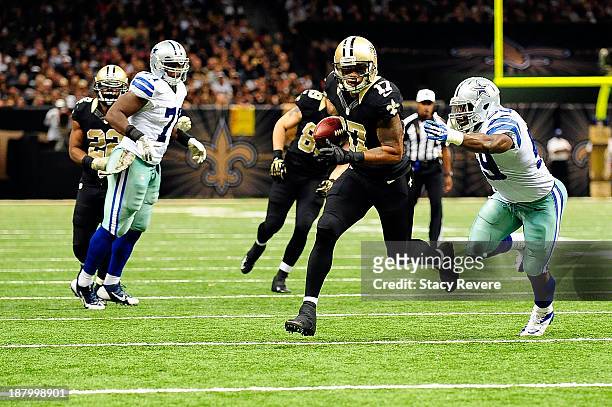 Ernie Sims of the Dallas Cowboys is unable to tackle Robert Meachem of the New Orleans Saints during a game at the Mercedes-Benz Superdome on...