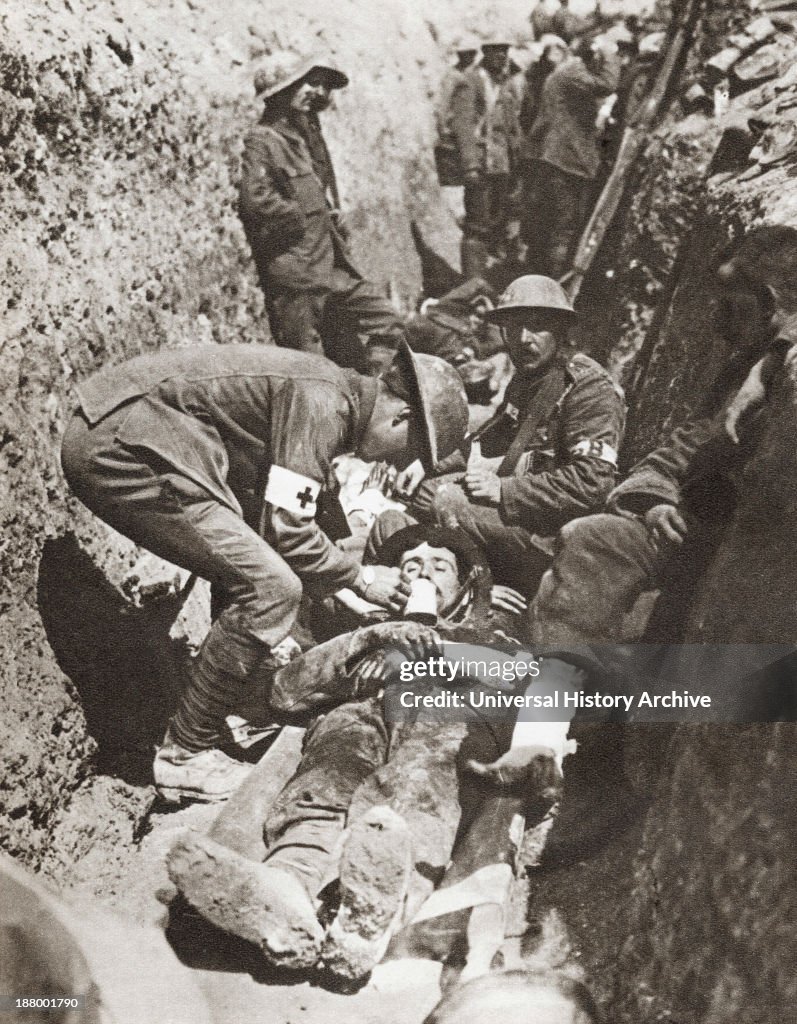 Stretcher Bearers Giving Aid To A Soldier Lying Wounded In A Trench On The Somme