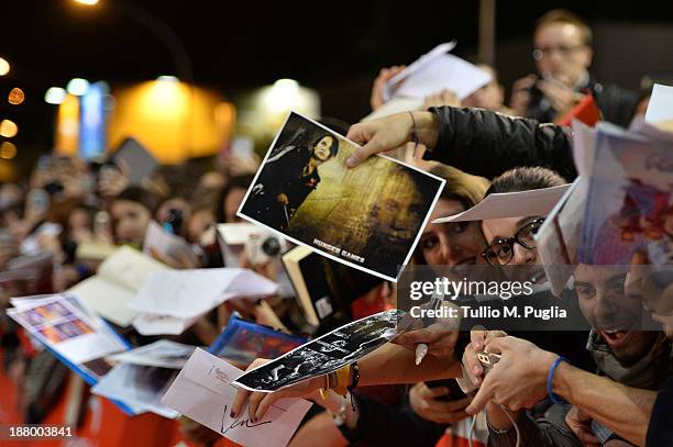 Fans wave posters at the 'The Hunger Games: Catching Fire' Premiere during The 8th Rome Film Festival at Auditorium Parco Della Musica on November...