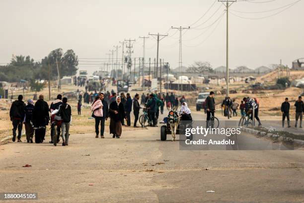Gazans living in some neighborhoods in Khan Yunis move to the southern city of Rafah after the announcement of Israeli forces on residents leaving...