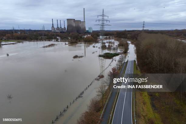 An aerial view taken on December 27, 2023 shows a decommissioned large coal-fired power plant by energy supplier RWE at the flooded Lippe river in...