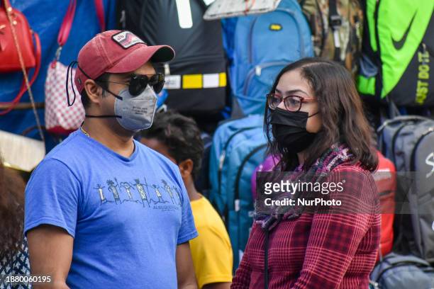 People are wearing masks amidst rising concerns of the new sub-variant JN.1 of COVID-19, as seen in Kolkata, India, on December 27, 2023. India has...