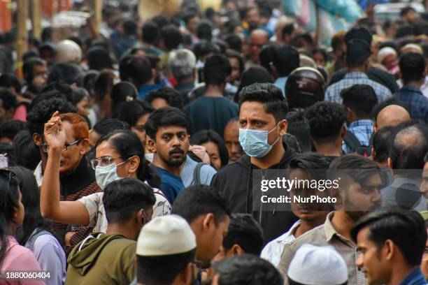 People are wearing masks amidst rising concerns of the new sub-variant JN.1 of COVID-19, as seen in Kolkata, India, on December 27, 2023. India has...