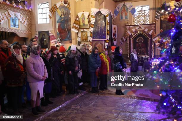 Devotees are attending the divine liturgy at the Church of the Nativity of the Blessed Virgin Mary on Christmas Day in Kryvorivnia, Ukraine, on...