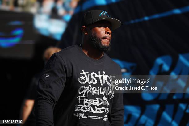 Offensive coordinator Thomas Brown of the Carolina Panthers walks onto the field before the game against the Green Bay Packers at Bank of America...