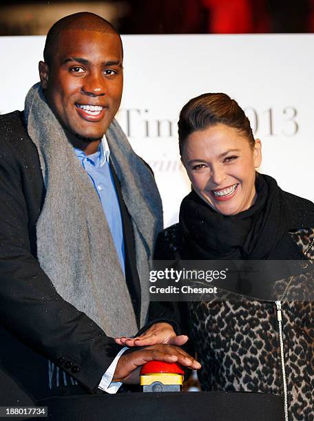 French Judoka Teddy Riner and television host, Sandrine Quetier launche the Christmas Lighting at Faubourg Saint-Honore on November 14, 2013 in...