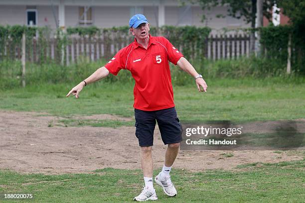 Phil Neil instructs young players during the Liverpool FC Legends Tour CSI and Coaching Clinic at Siphosethu Primary School on November 14, 2013 in...