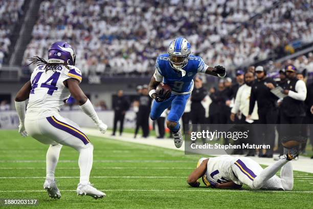 Jameson Williams of the Detroit Lions carries the ball after a reception against the Minnesota Vikings during the first quarter at U.S. Bank Stadium...