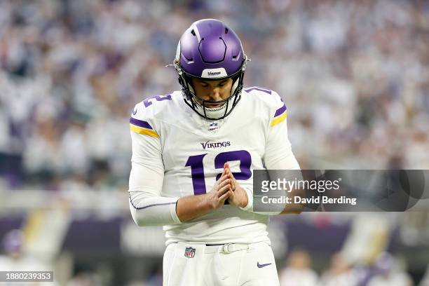 Nick Mullens of the Minnesota Vikings celebrates a touchdown by teammate Ty Chandler against the Detroit Lions during the first quarter at U.S. Bank...