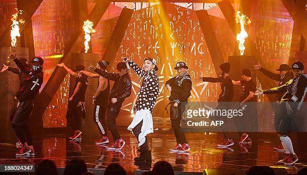 This photo taken on November 14, 2013 shows South Korean idol Tae-Yang performing at Cable TV music program Mnet Countdown in Seoul. REPUBLIC OF...