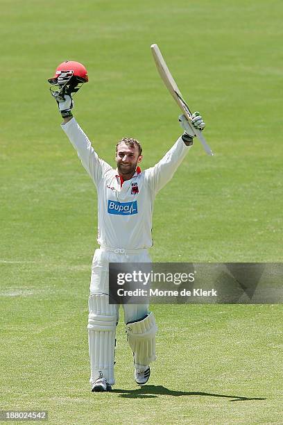 Phillip Hughes of the Redbacks celebrates after reaching 100 runs during day three of the Sheffield Shield match between the Redbacks and the...