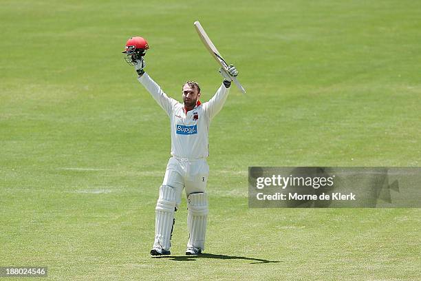 Phillip Hughes of the Redbacks celebrates after reaching 100 runs during day three of the Sheffield Shield match between the Redbacks and the...