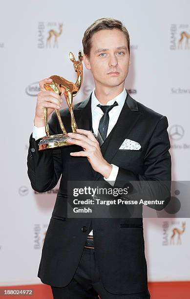 Tom Schilling poses with the Bambi for best actor at the Bambi Awards at Stage Theater on November 14, 2013 in Berlin, Germany.