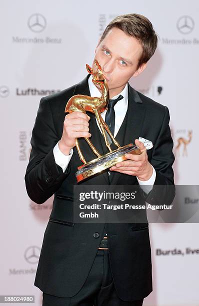 Tom Schilling poses with the Bambi for best actor at the Bambi Awards at Stage Theater on November 14, 2013 in Berlin, Germany.