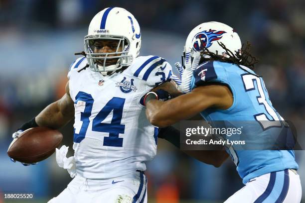 Trent Richardson of the Indianapolis Colts carries the ball against the defense of Michael Griffin of the Tennessee Titans in the second quarter at...