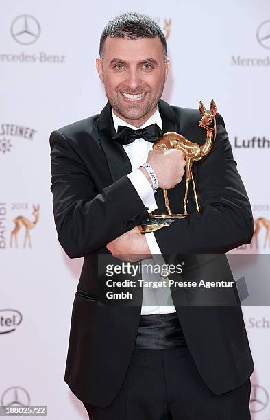 Ismail Oener poses with the Bambi for integration at the Bambi Awards at Stage Theater on November 14, 2013 in Berlin, Germany.