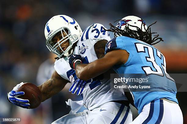 Trent Richardson of the Indianapolis Colts carries the ball against the defense of Michael Griffin of the Tennessee Titans in the second quarter at...