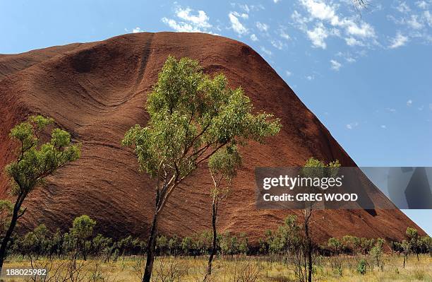 Australia-tourism-indigenous-Uluru,FEATURE by Madeleine Coorey This photo taken on October 11, 2013 shows Uluru, formerly known as Ayers Rock, a...