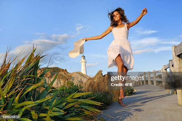 woman by the lighthouse, new zealand - woman skipping stock pictures, royalty-free photos & images