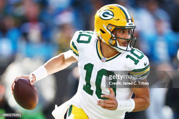 Jordan Love of the Green Bay Packers scrambles with the ball during the second quarter against the Carolina Panthers at Bank of America Stadium on...
