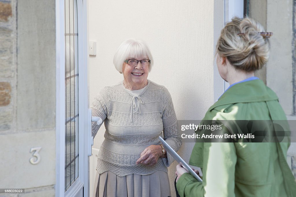 Senior woman answers door to community careworker