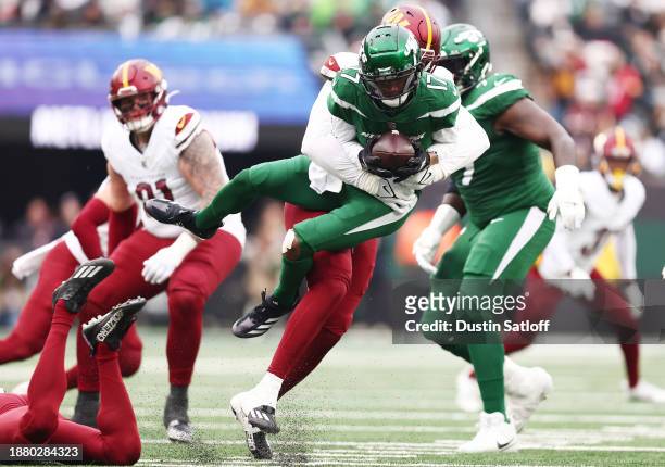 Garrett Wilson of the New York Jets is tackled by James Smith-Williams of the Washington Commanders during the second quarter at MetLife Stadium on...