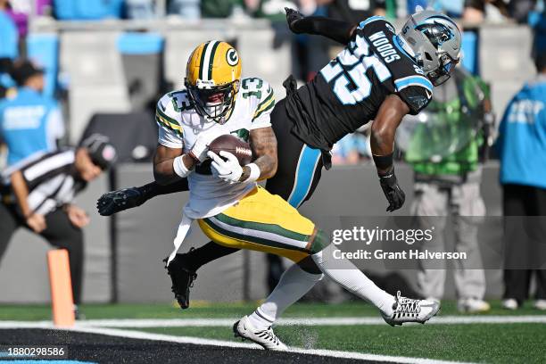 Dontayvion Wicks of the Green Bay Packers scores a touchdown during the second quarter against the Carolina Panthers at Bank of America Stadium on...