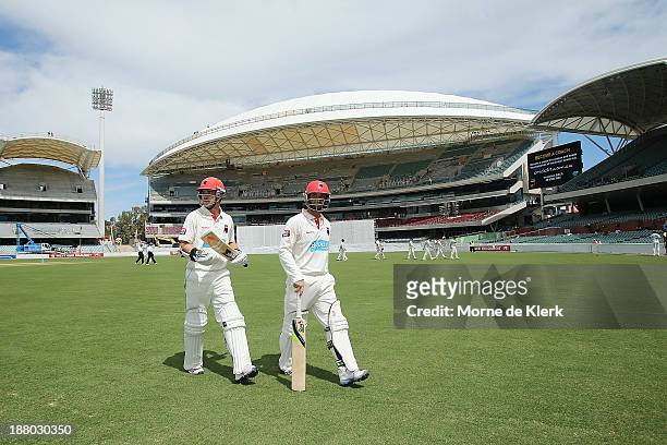 Travis Head and Phillip Hughes of the Redbacks leaves the field at tea during day three of the Sheffield Shield match between the Redbacks and the...