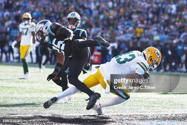 Dontayvion Wicks of the Green Bay Packers scores a touchdown during the second quarter against the Carolina Panthers at Bank of America Stadium on...