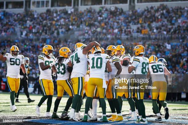 The Green Bay Packers celebrate after Dontayvion Wicks of the Green Bay Packers scores a touchdown during the second quarter against the Carolina...