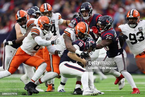 Case Keenum of the Houston Texans is sacked by Alex Wright of the Cleveland Browns during the second quarter at NRG Stadium on December 24, 2023 in...