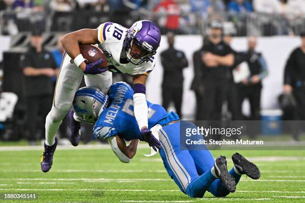 Justin Jefferson of the Minnesota Vikings carries the ball against Ifeatu Melifonwu of the Detroit Lions during the second quarter at U.S. Bank...
