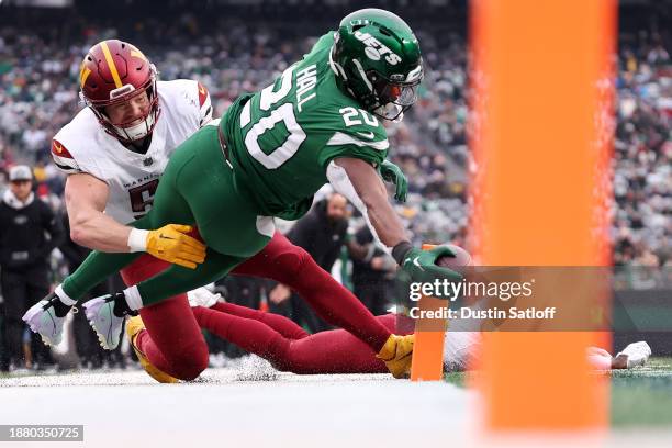 Breece Hall of the New York Jets scores a touchdown during the second quarter against the Washington Commanders at MetLife Stadium on December 24,...