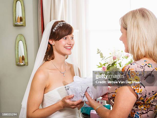 mother gives present to bride. - wedding gift stock pictures, royalty-free photos & images