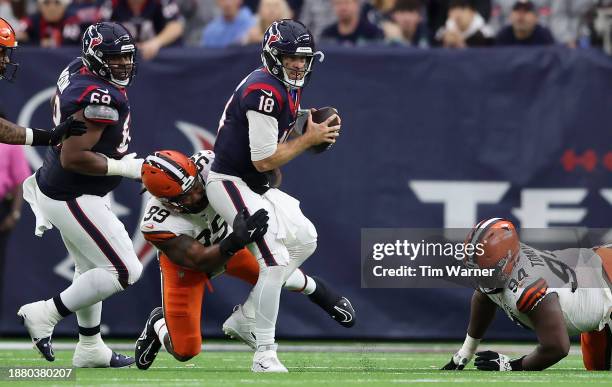 Case Keenum of the Houston Texans is sacked by Za'Darius Smith of the Cleveland Browns during the second quarter at NRG Stadium on December 24, 2023...