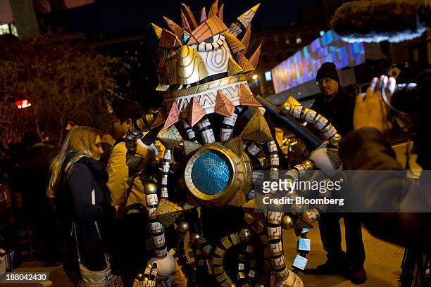 Character from the video game Knack poses as fans line up to attend the Sony PlayStation 4 midnight launch event in New York, U.S., on Thursday, Nov....