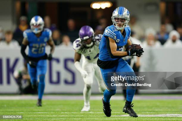 Amon-Ra St. Brown of the Detroit Lions carries the ball against the Minnesota Vikings during the third quarter at U.S. Bank Stadium on December 24,...