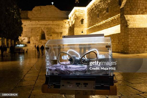 An installation showing baby Jesus in an incubator in solidarity with children in Gaza by an artist Rana Bishara and Sana Farah is displayed next to...