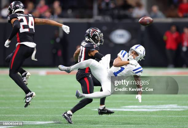 Josh Downs of the Indianapolis Colts failed to make a catch while defended by Mike Hughes and A.J. Terrell of the Atlanta Falcons during the fourth...