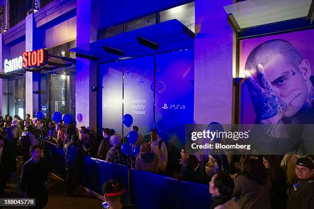 Fans wait in line outside a Game Stop store to attend the Sony PlayStation 4 midnight launch event in San Francisco, California, U.S., on Thursday,...