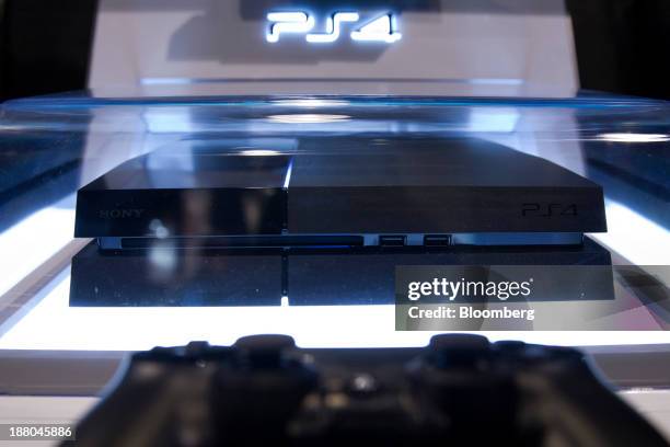 Sony PlayStation 4 console stands on display at a Game Stop store during the Sony PlayStation 4 midnight launch event in San Francisco, California,...