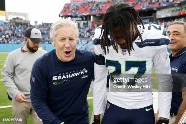 Head coach Pete Carroll and Riq Woolen of the Seattle Seahawks walk off the field after a win over the Tennessee Titans at Nissan Stadium on December...