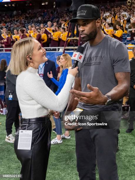 Former Detroit Lions wide receiver and NFL Hall Of Famer Calvin Johnson speaks with ESPN Personality Tori Petry during the Quick Lane Bowl between...